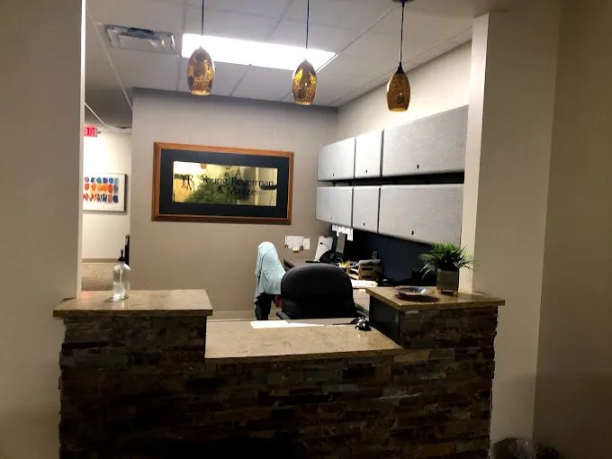 Office reception area with a counter, pendant lights and wall cabinets