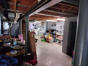 Before photo of a cluttered basement in West Chester, Ohio, prior to the deep cleaning and organizing project.