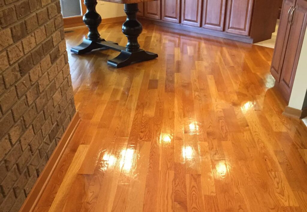 Professional hardwood floor buffing service by American Maids and Floor Cleaning Specialists in Cincinnati, restoring the natural beauty of wood floors