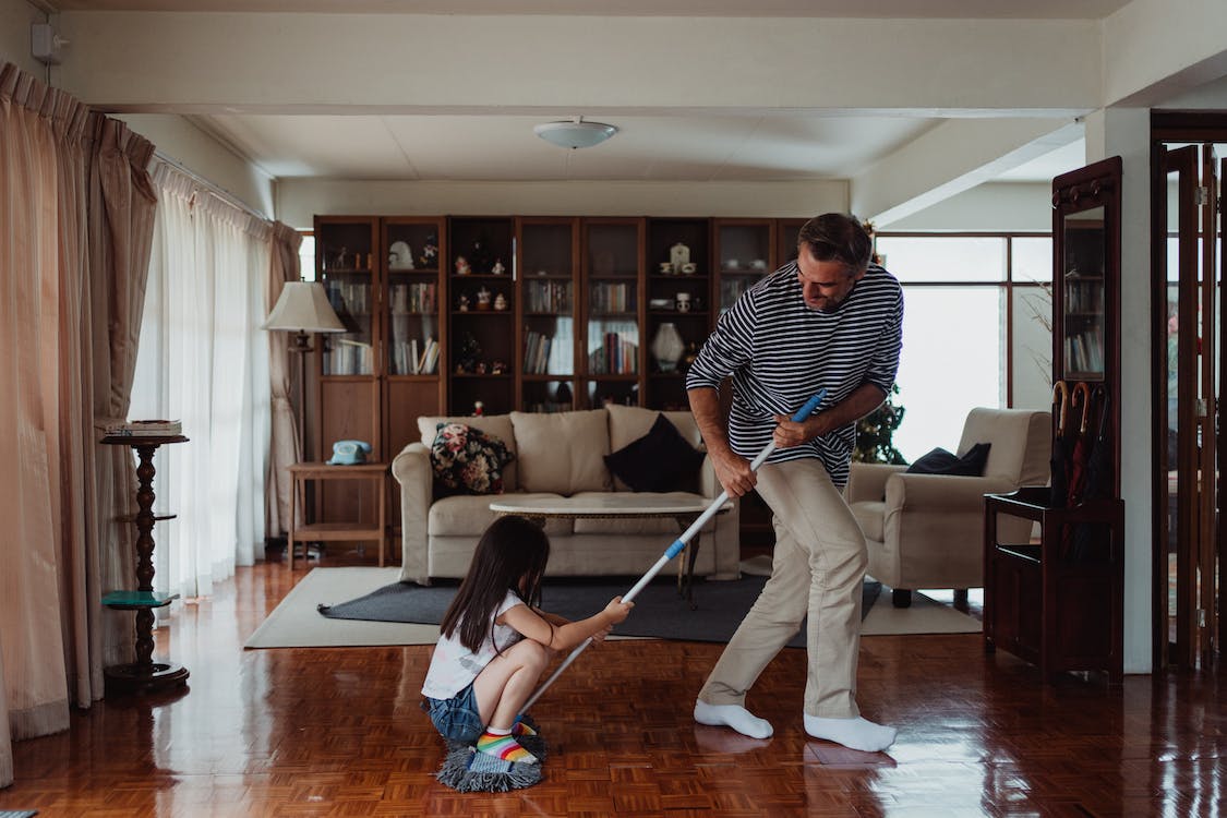 Cincinnati homeowner achieving a polished finish using a microfiber mop on hardwood floors.